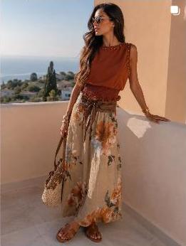 Model in a rust-orange dress on a terrace, Watermellon Concept Store